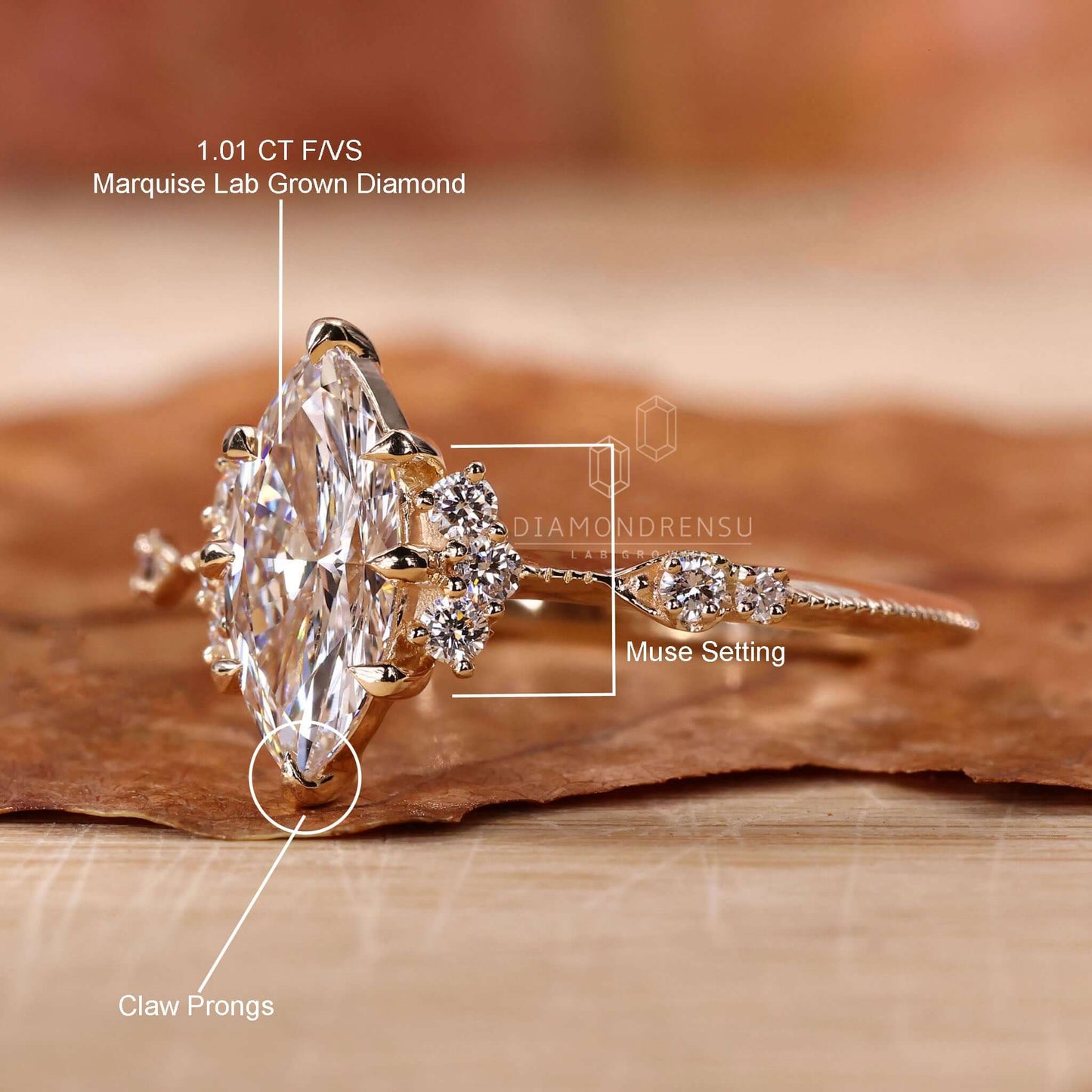 A handcrafted marquise cut diamond engagement ring with vintage charm, featuring round sidestones, knife edge band, and intricate miligrain work.