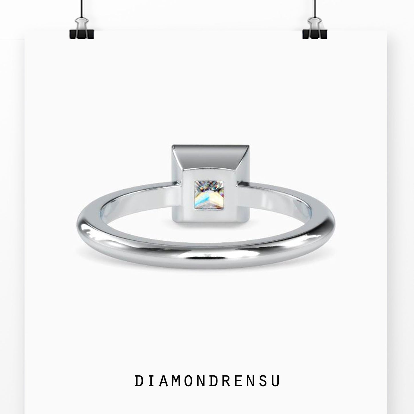 Gorgeous princess cut solitaire ring featuring a bezel setting for added elegance.