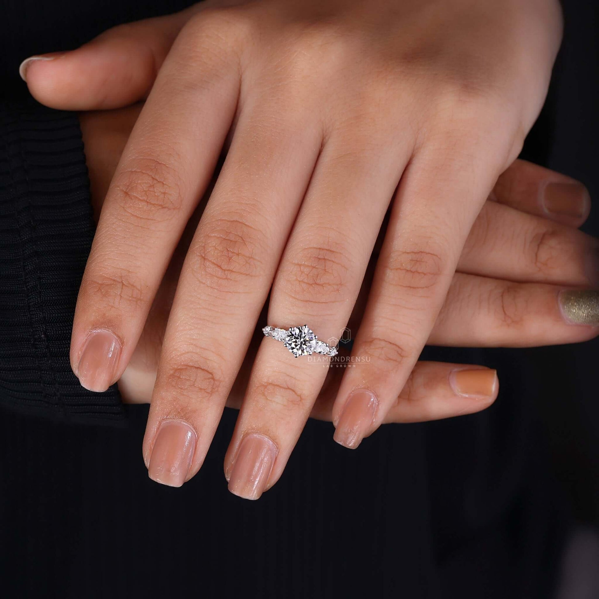 Luminous round diamond engagement ring on hand, capturing the essence of a romantic proposal.