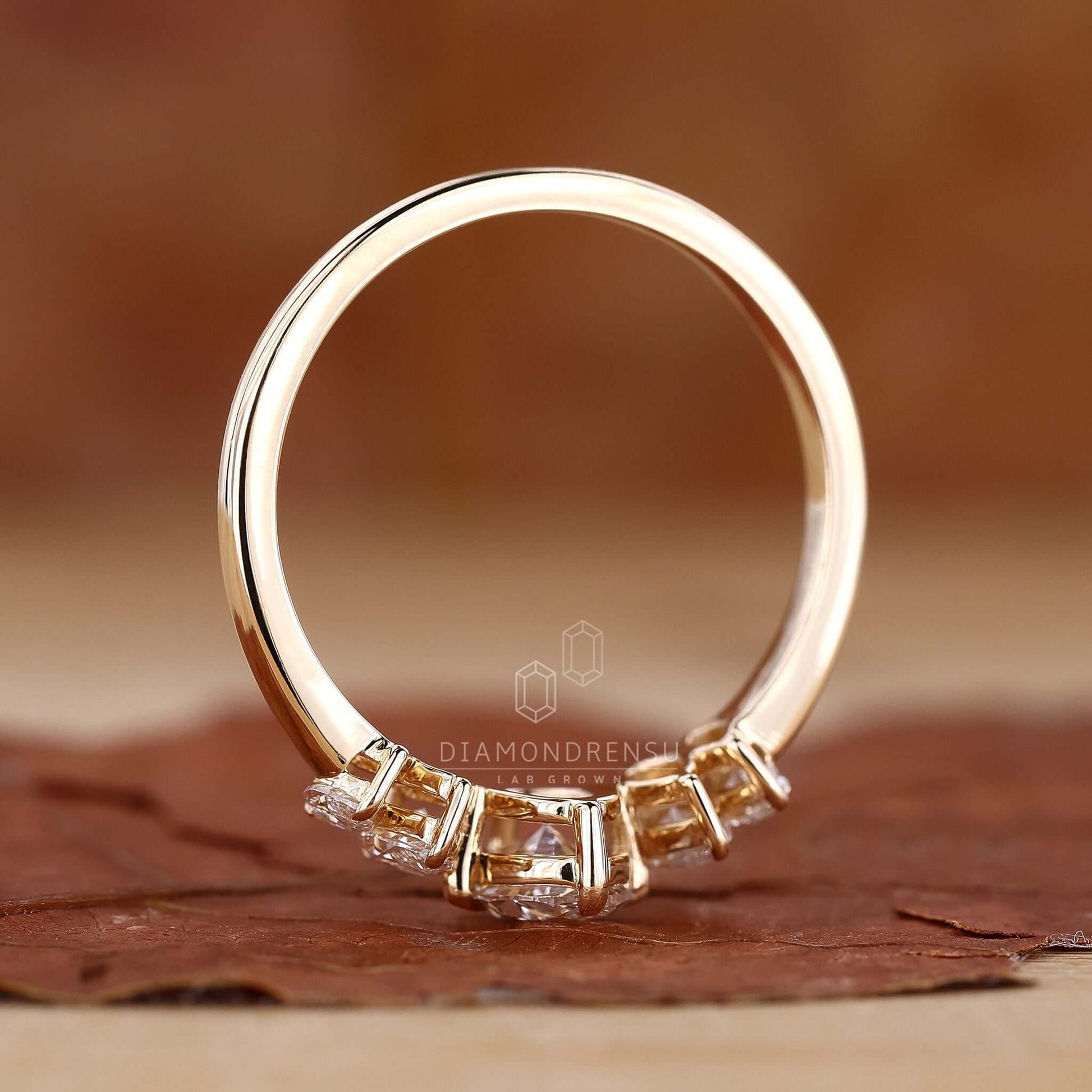Hand wearing a gold oval diamond engagement ring, emphasizing its radiant elegance and style