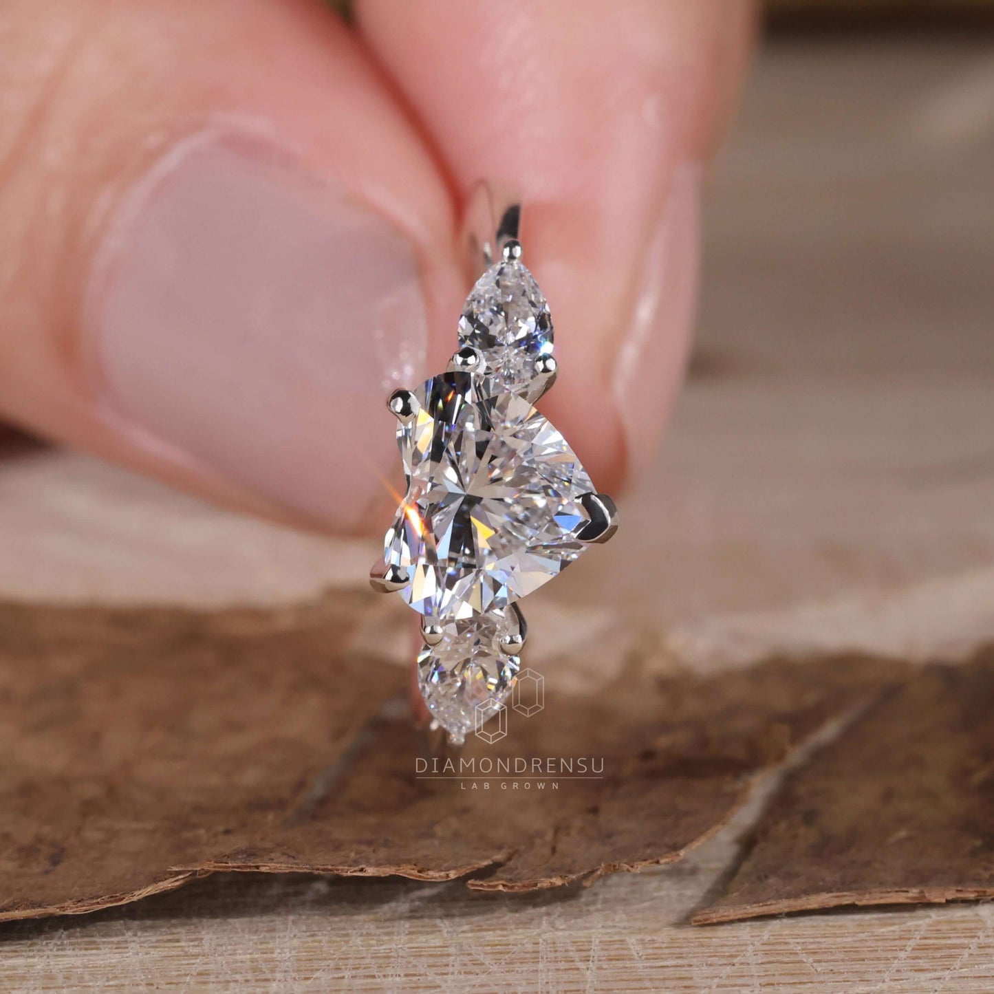 Heart shaped ring with three stones on model