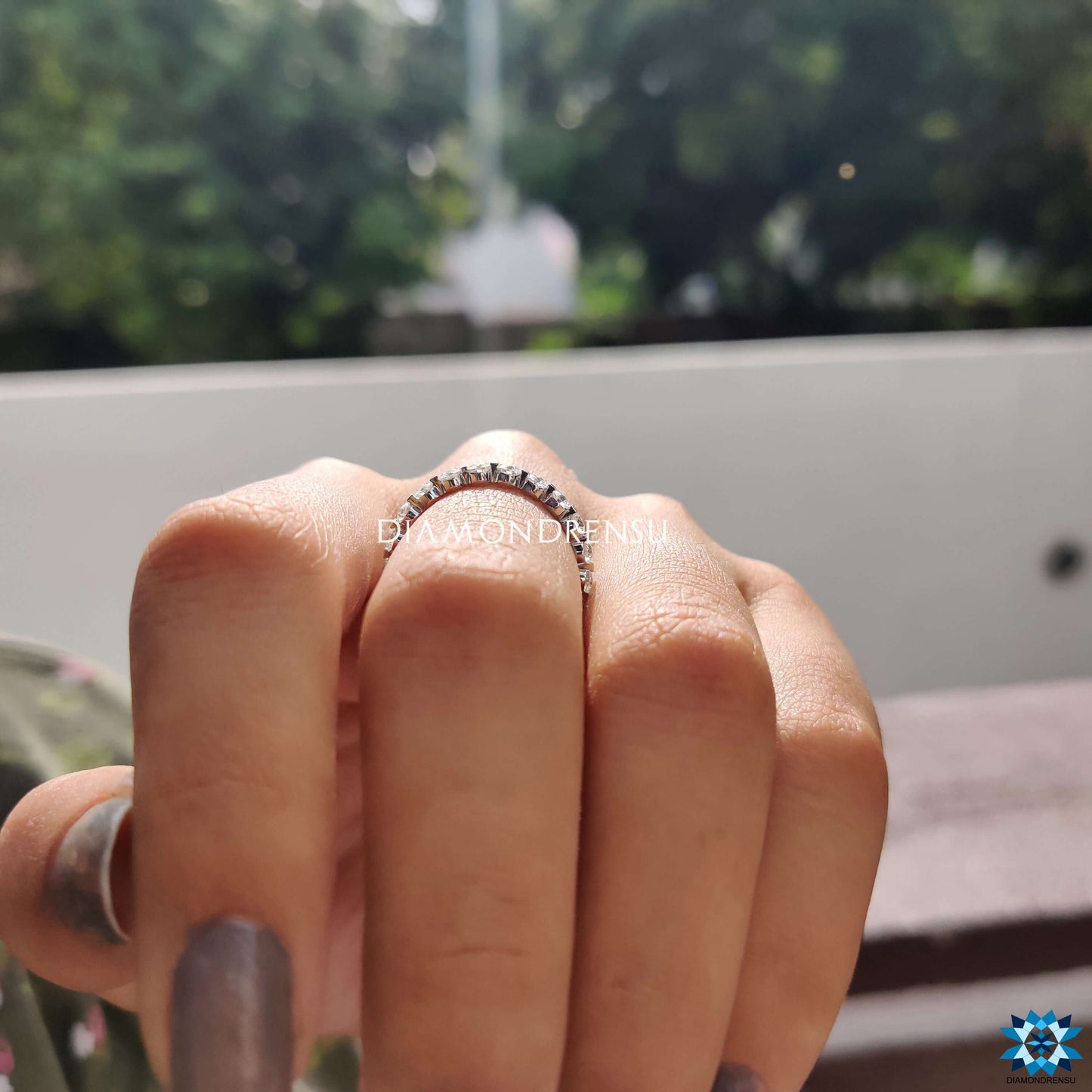 Simple and chic simple wedding band featuring elegant design and radiant moissanite stones.
