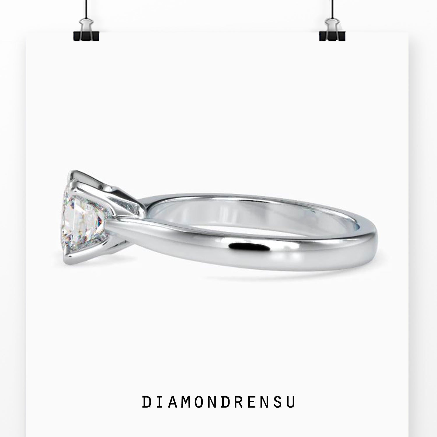 Solitaire ring featuring a princess cut diamond with a prong setting
