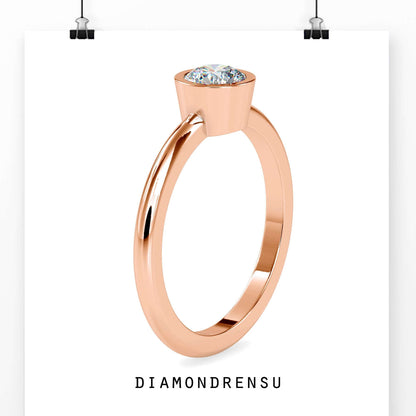 Simple diamond ring single featuring a bezel set lab grown diamond.
