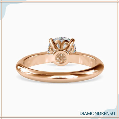 Beautifully crafted diamondrensu engagement ring featuring a knife edge setting and a round diamond.
