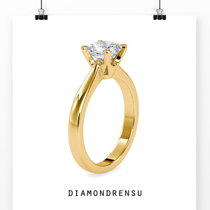 Handmade ring with a diamond solitaire in a tapered shank yellow gold setting
