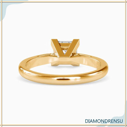 Timeless cathedral style ring featuring a princess cut diamond in a solitaire setting.