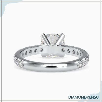 Pave engagement ring with a cushion cut diamond, available in rose, white, and yellow gold.
